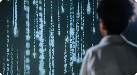 A person watching a wall of streaming data